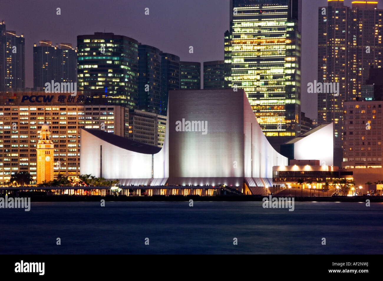 The Hong Kong Cultural Centre & Clocktower at Night, Tsim Sha Tsui, Kowloon, Hong Kong, China Stock Photo