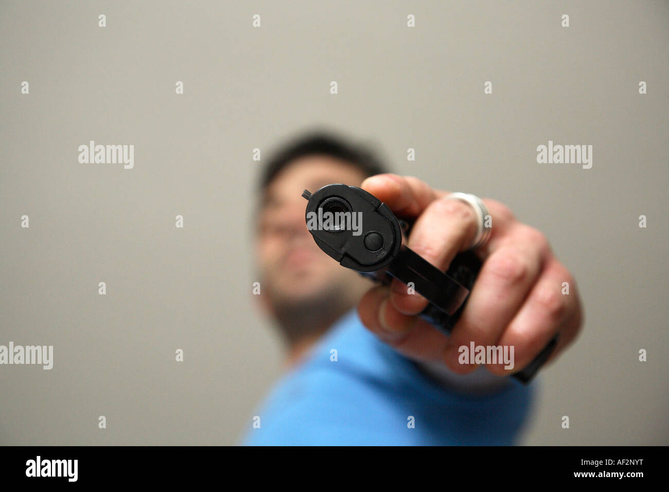 man-pointing-hand-gun-down-at-camera-AF2
