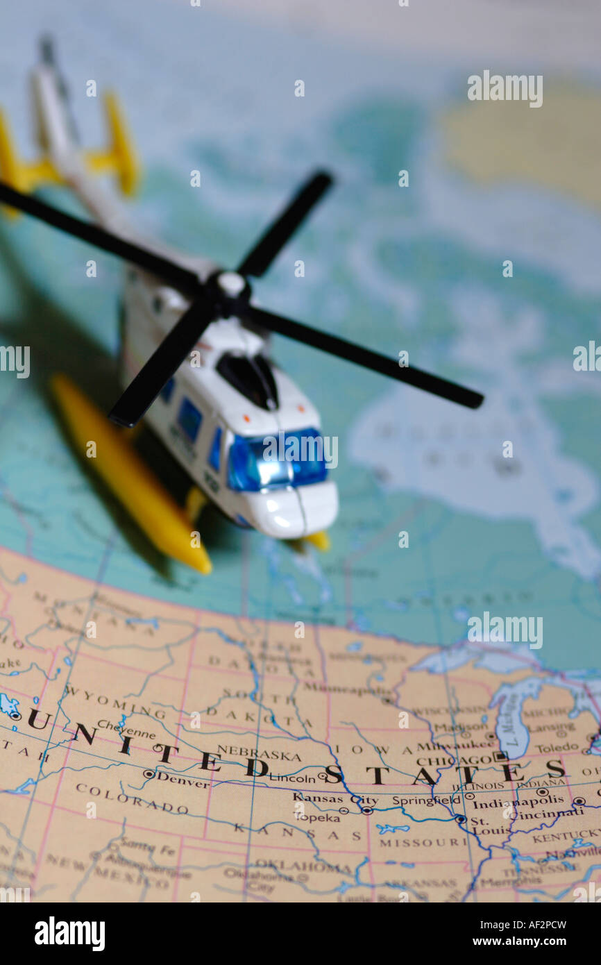 Toy helicopter next to map of United States of America Stock Photo