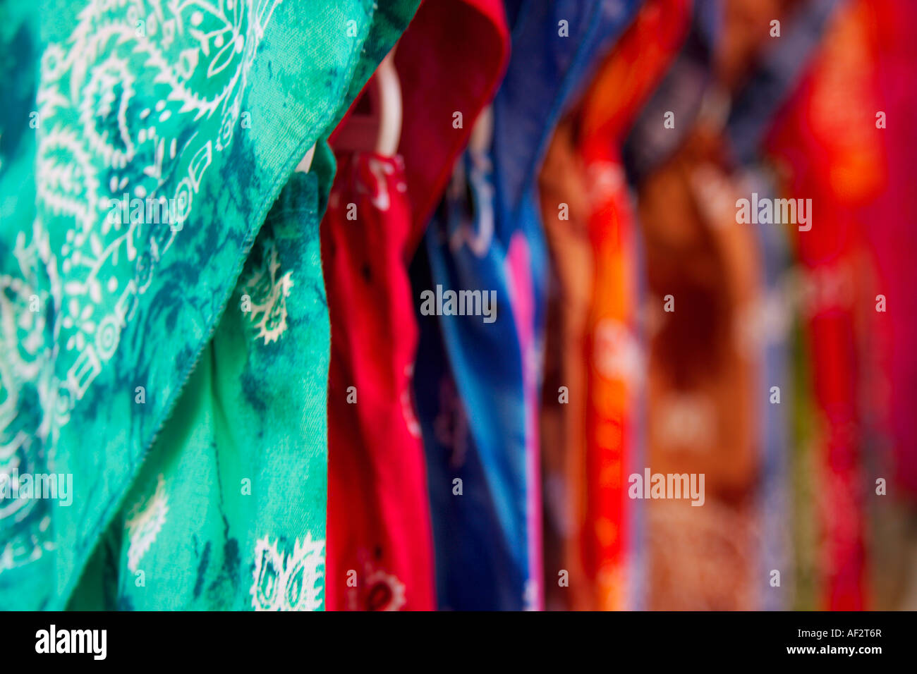 Brightly coloured dresses for sale on a French market. Languedoc Roussillon. France. Stock Photo