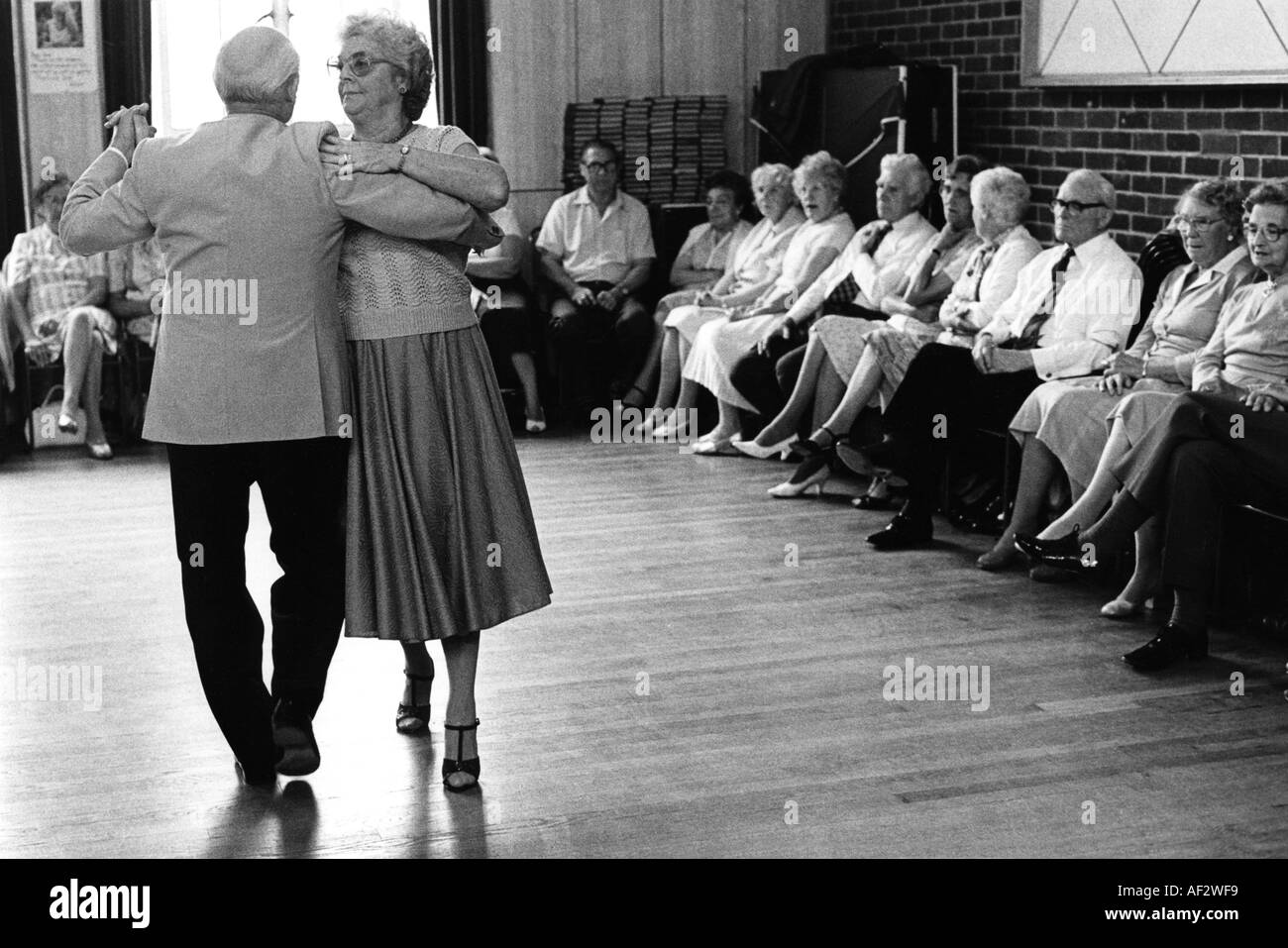 Couple demonstrating new dance steps at afternoon tea dance in small