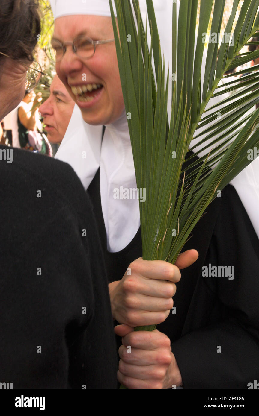 Israel Jerusalem Sainte Anne Church Palm Sunday catholic Procession Portrait of a nun holding a palm leave and laughing Stock Photo