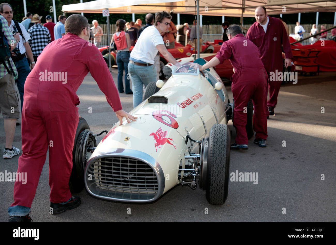 1952 Ferrari 375 'Grant Piston Ring Special' is pushed into the paddock by mechanics at the Goodwood Festival of Speed. Stock Photo