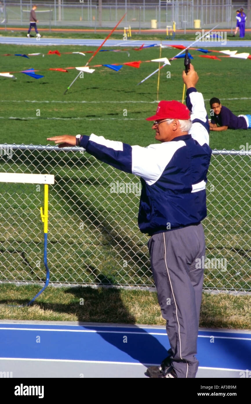 A High School Track Official in Salt Lake City, Utah, USA Preparing to Fire the Starting Gun Before a Race. Stock Photo