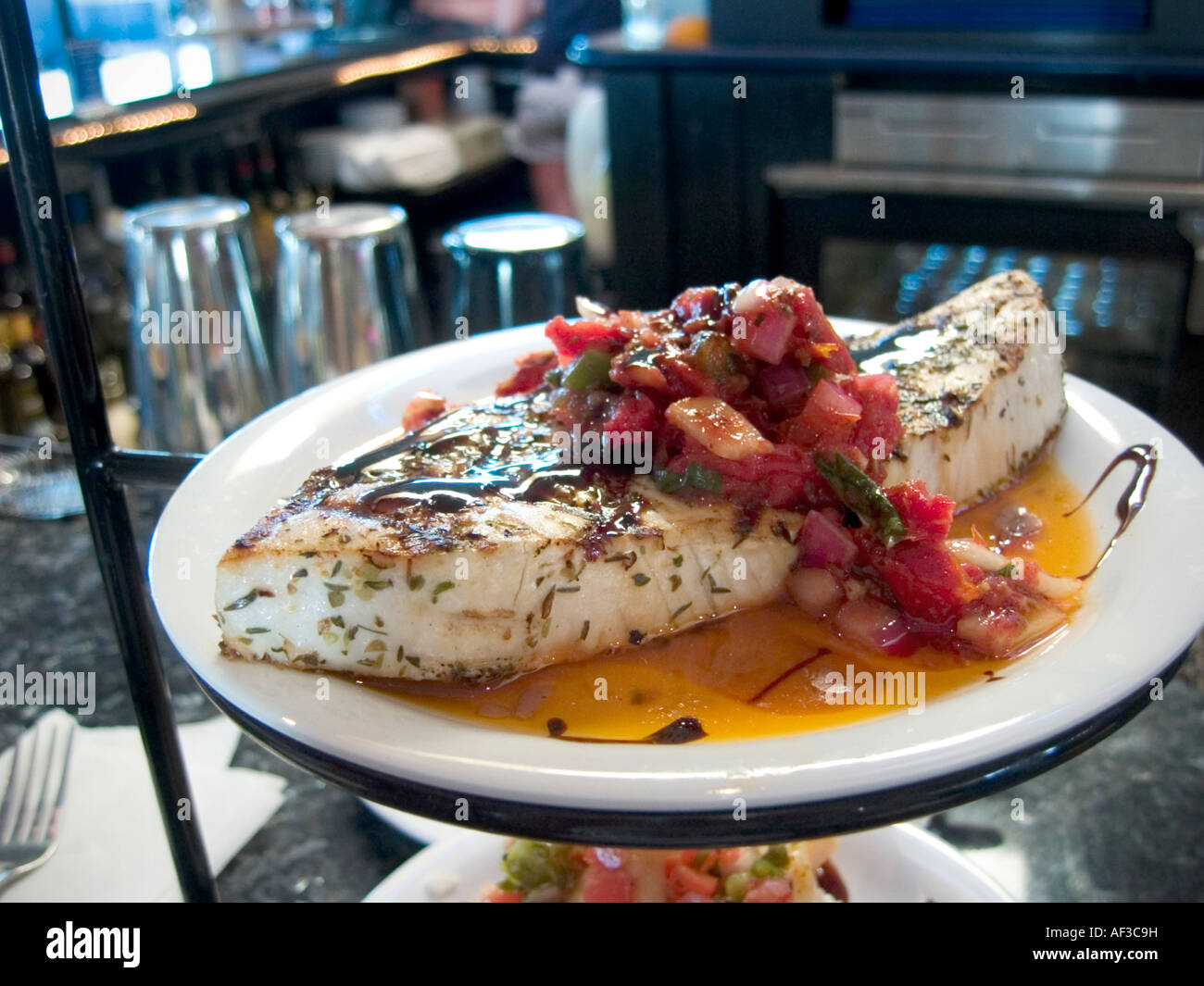 Gourmet presentation of a nice fillet of fish with chutney. Stock Photo