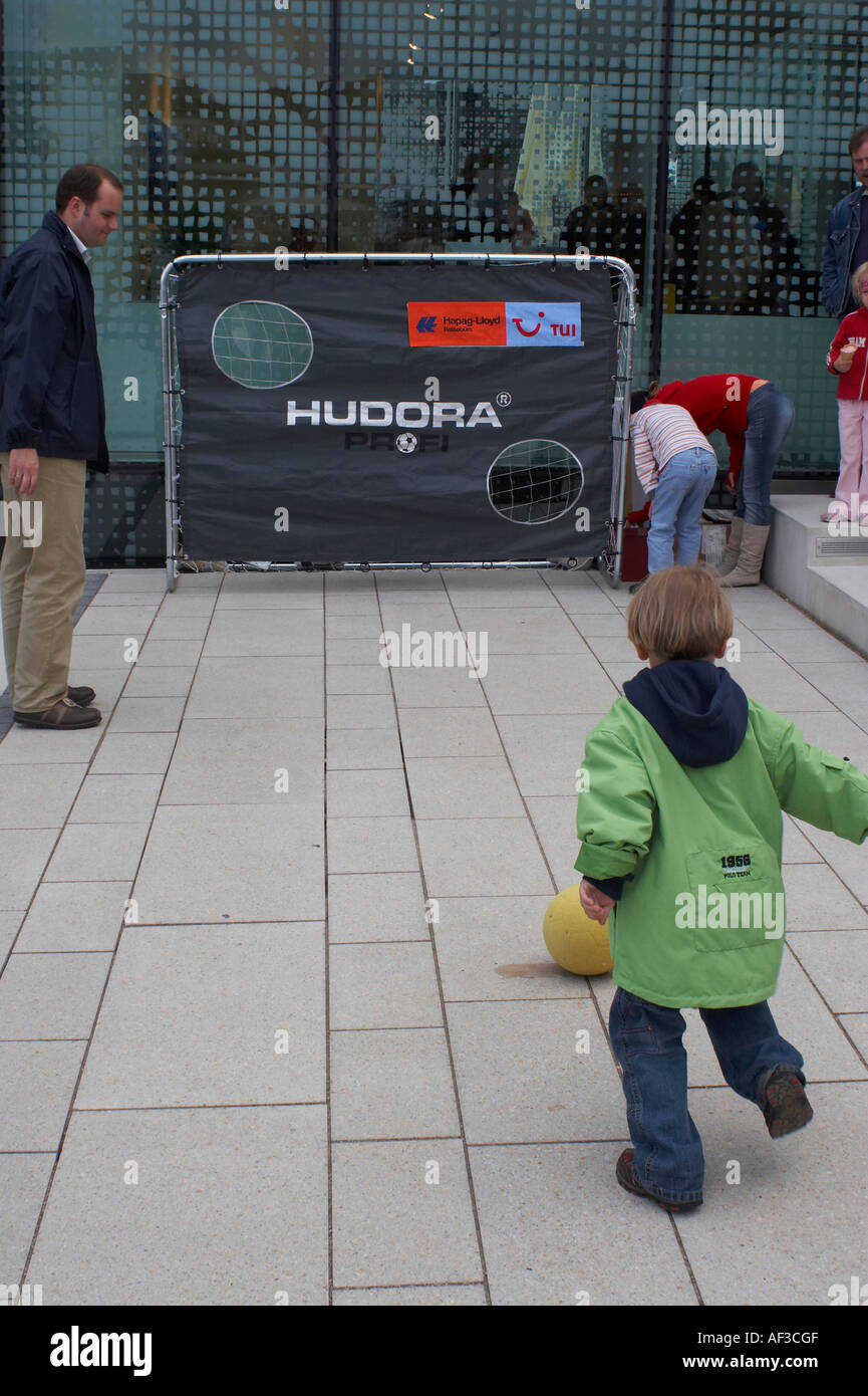 Event in Hamburg's marketplace because of FIFA 2006. Children trying their luck hand at footnall play. Stock Photo