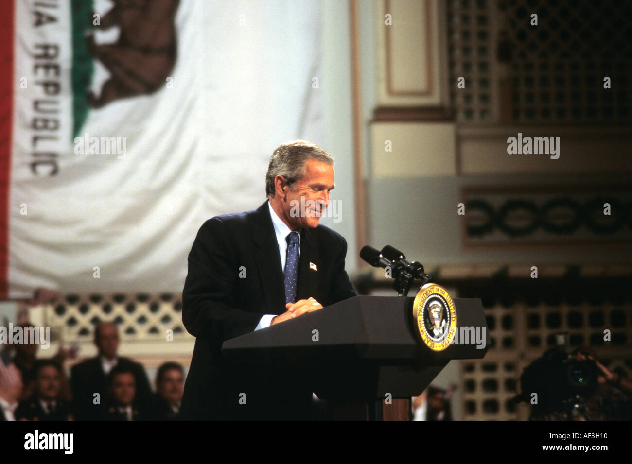 President George Walker Bush smiles as a heckler is removed during a speech in Stockton California. © Craig M. Eisenberg Stock Photo