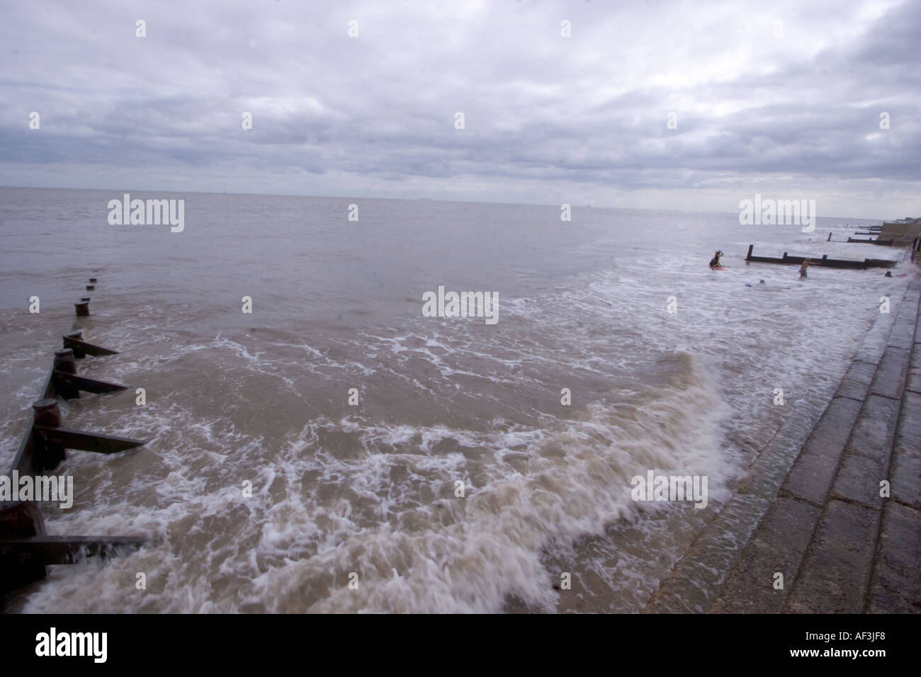 Seascape with groynes sea defences flood barriers Frinton Essex Stock Photo