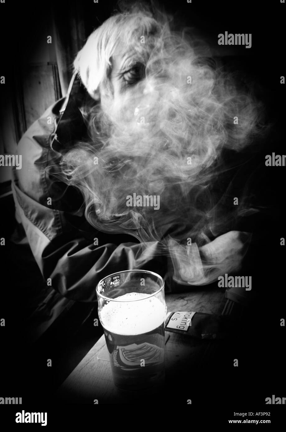 man smoking pipe in pub Stock Photo