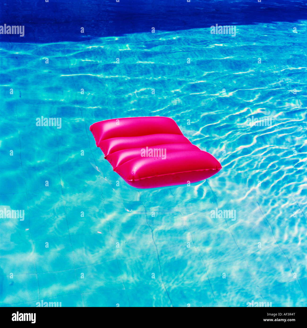 Red lilo in a swimming pool Stock Photo