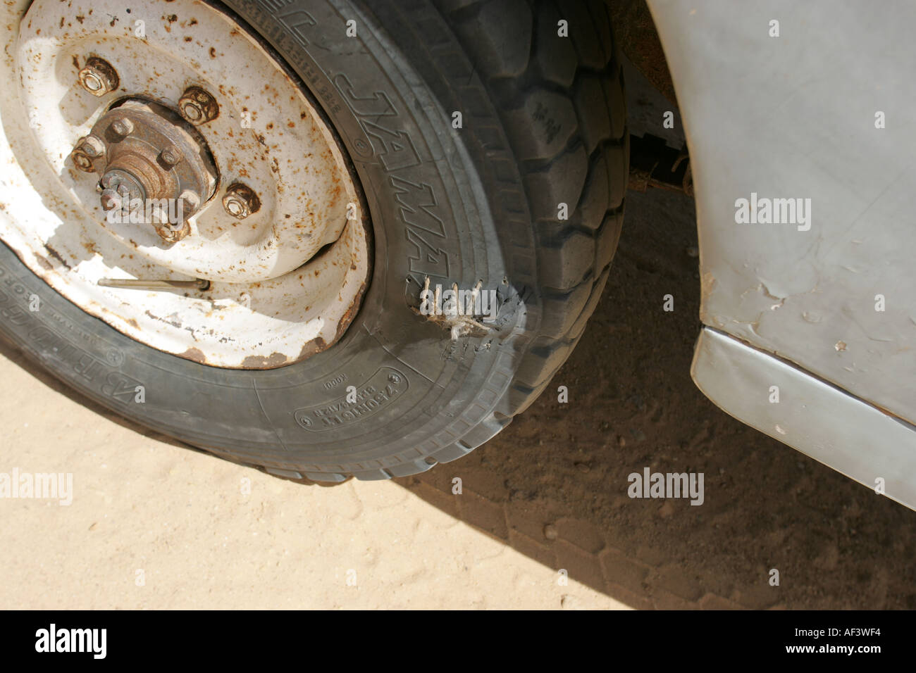 a mercedes 230e crossing the sahara desert with a puncture Stock Photo