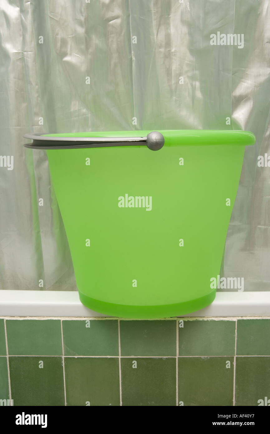 Bucket on bath collecting water Stock Photo Alamy