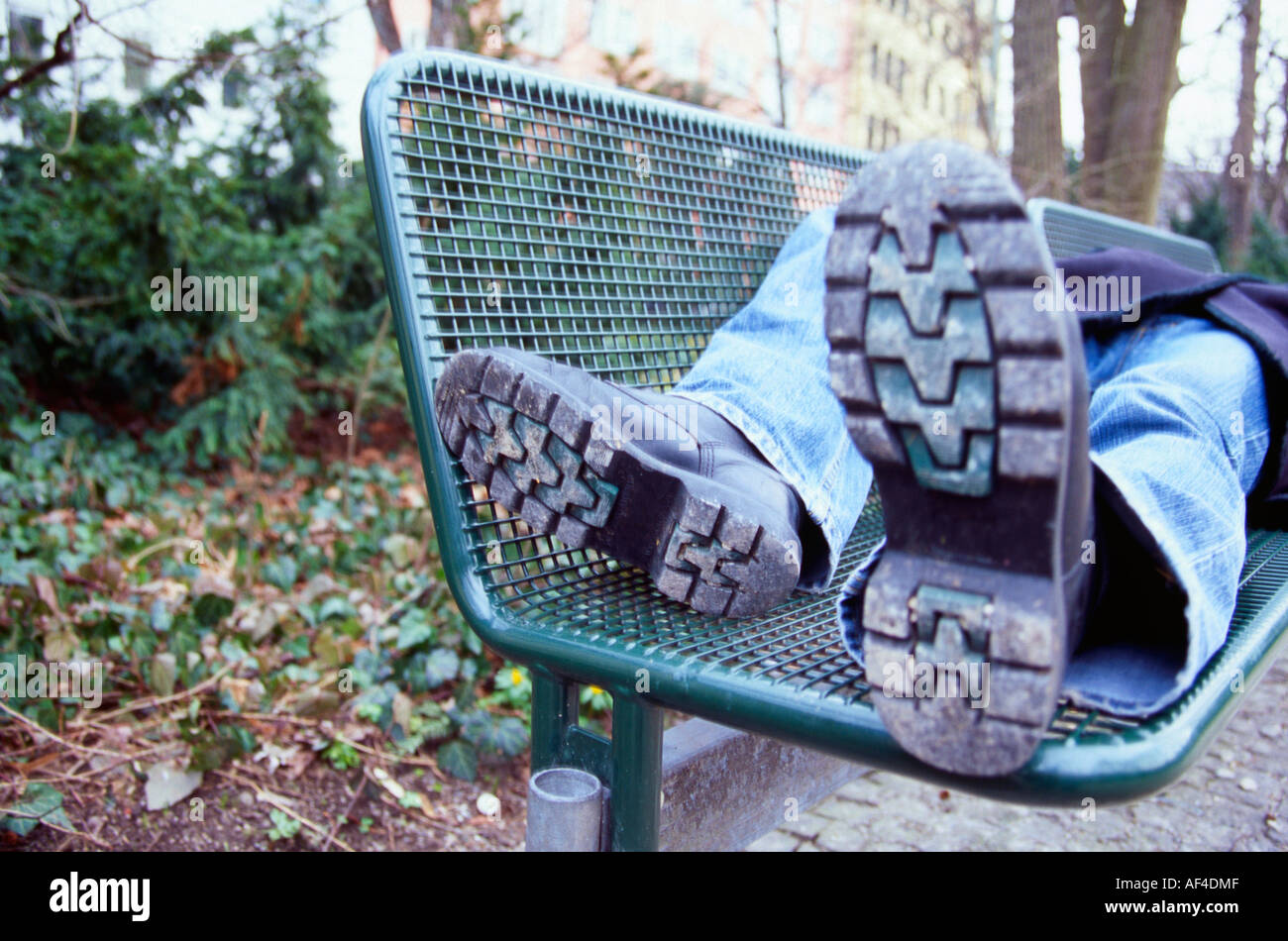 Homeless man sleeping on bench hi-res stock photography and images - Alamy