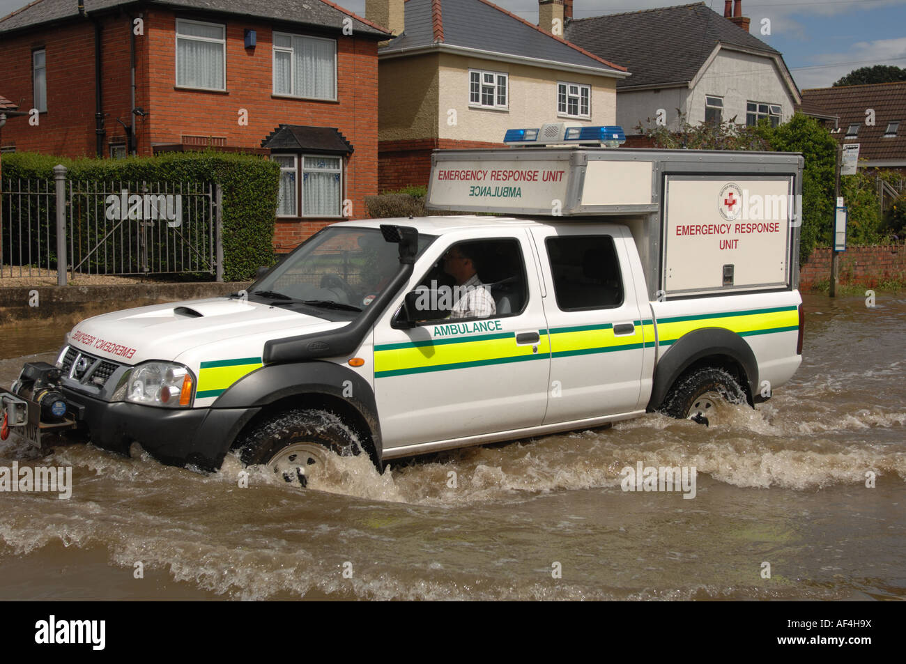 British Red Cross lorry driving through floods in the Longford area of Gloucester England July 2007 after severe flooding Stock Photo