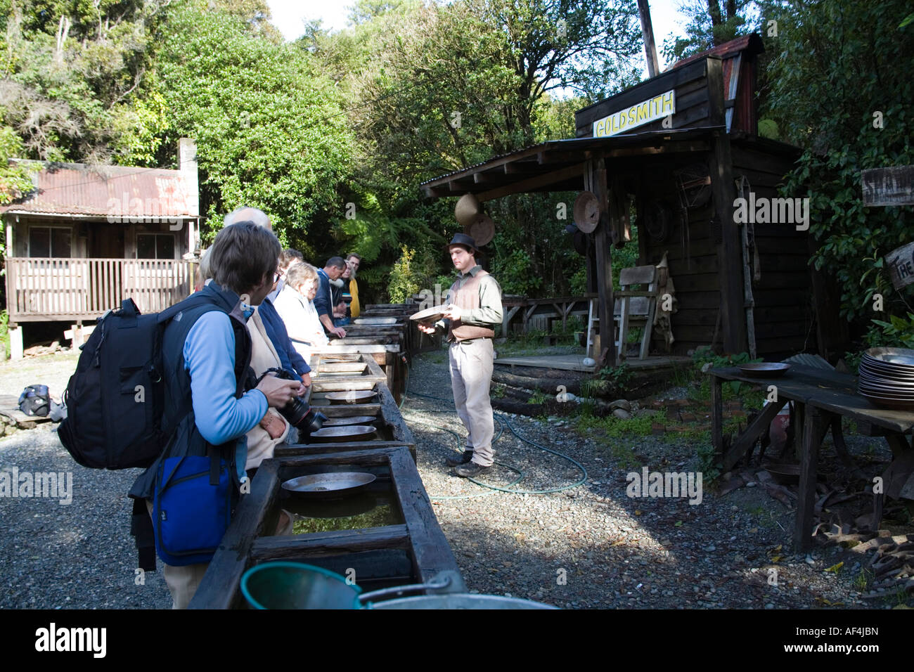 GREYMOUTH CENTRAL SOUTH ISLAND NEW ZEALAND May Tourists trying their hand at gold panning in Shantytown Stock Photo