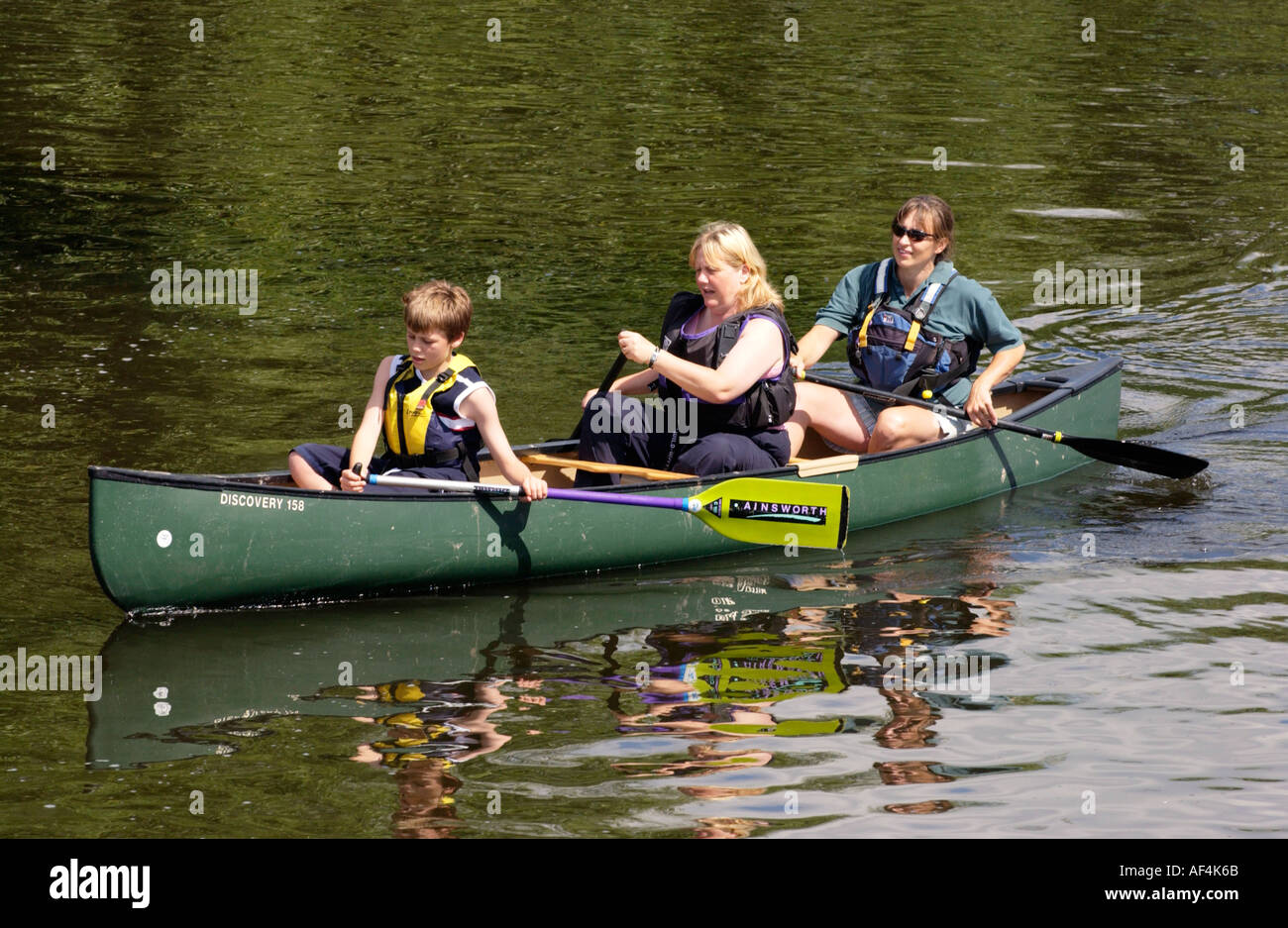 Canadian type open canoe on the River Wye at Sellack Herefordshire