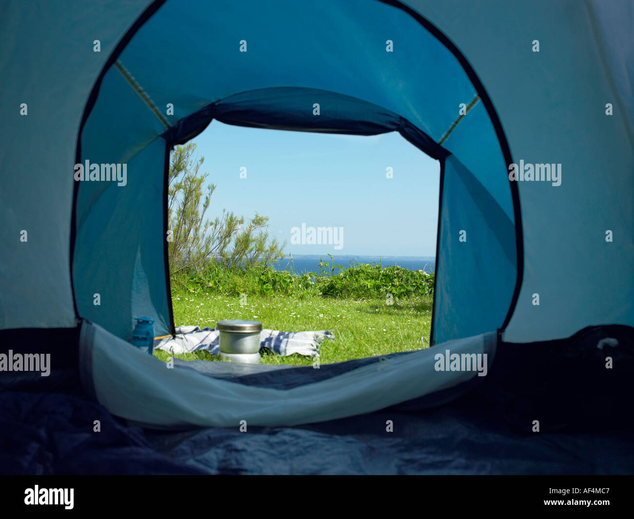 View through tent opening on to green field Stock Photo Alamy