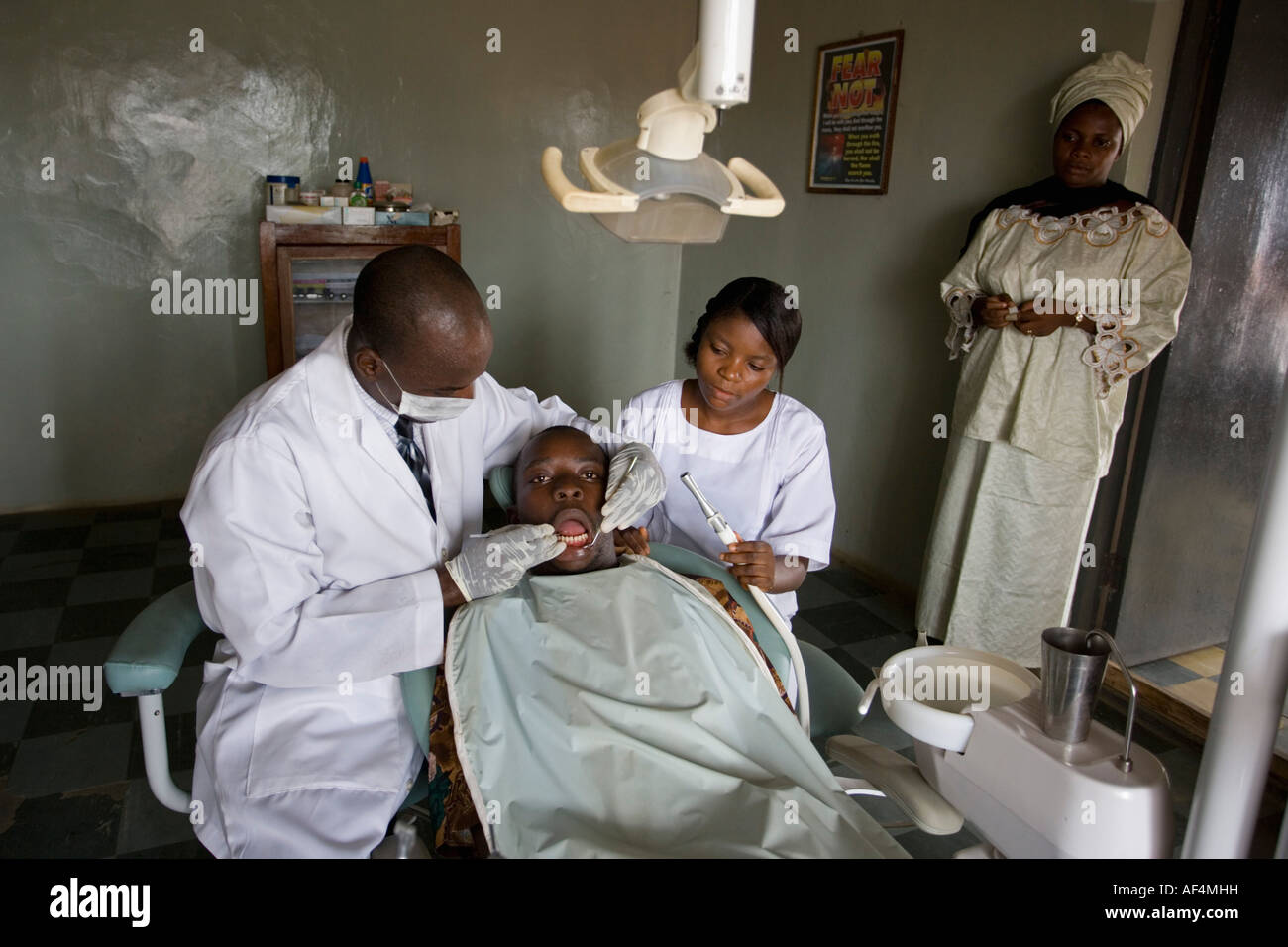 Nigeria Lagos, Dentist checking teeth of patient at dental clinic Stock