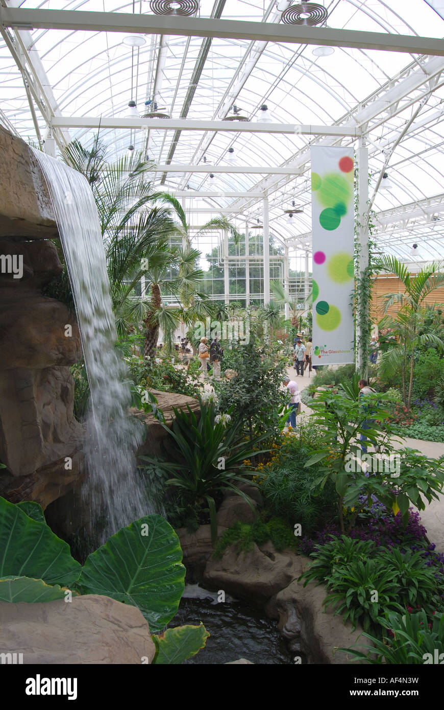 Indoor plants and waterfall, The Glasshouse, RHS Wisley Gardens, Woking, Surrey, England, United Kingdom Stock Photo