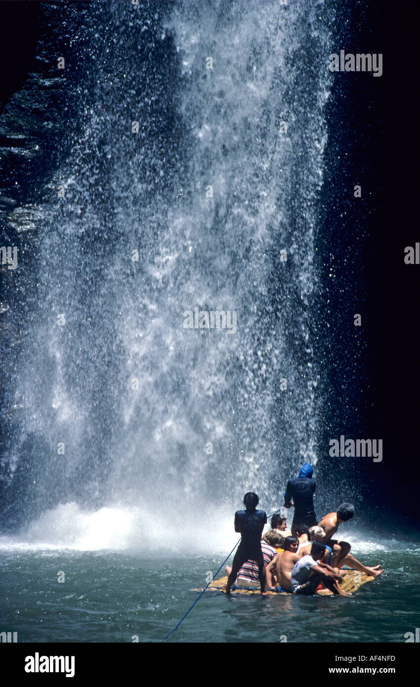People on a raft excursion for the excitement of getting soaked under the waterfall at Pagsanjan River Falls The Philippines Stock Photo