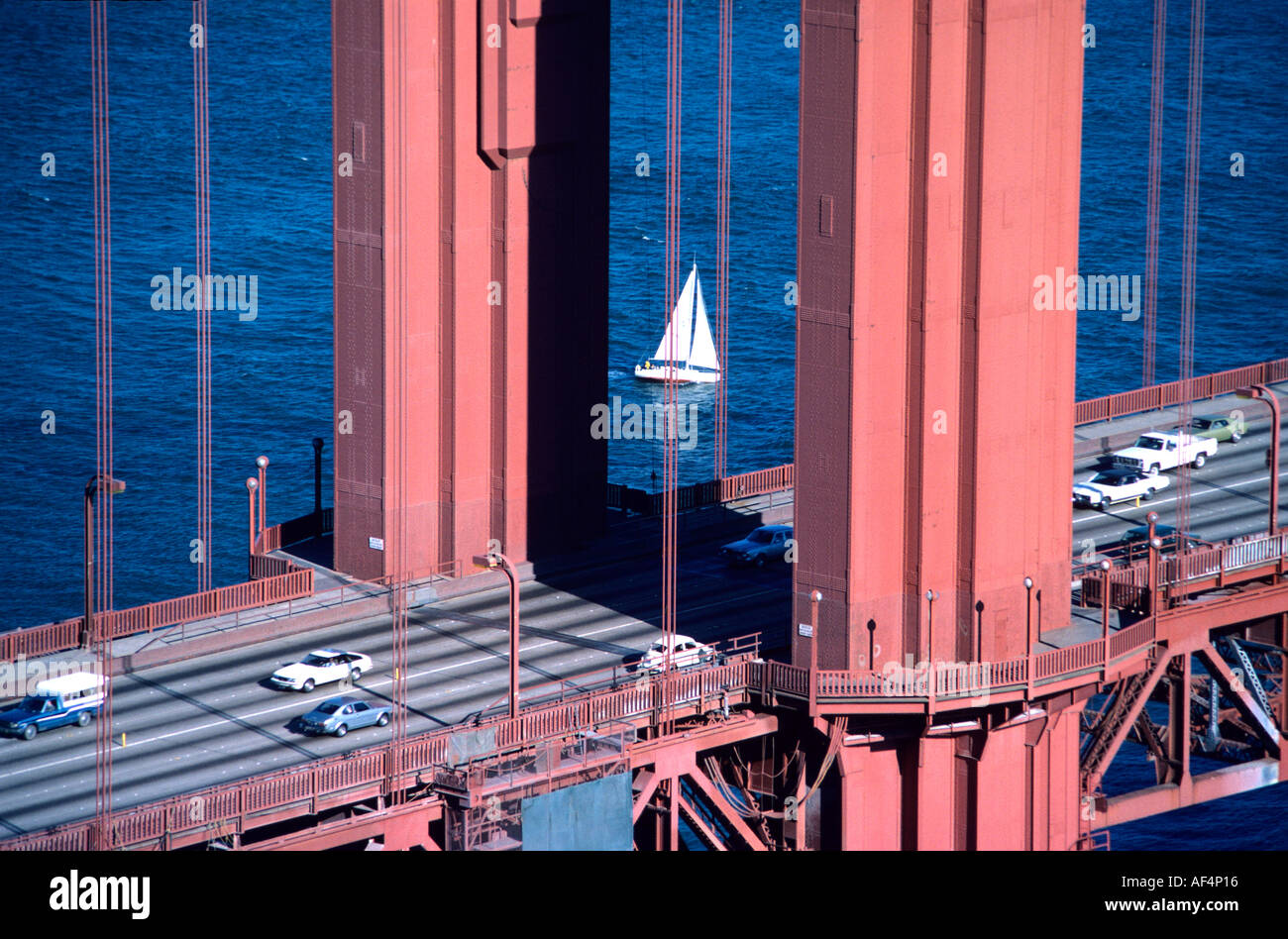 Yacht seen sailing between a pair of main supporting pillars of the Golden Gate Bridge in San Francisco California USA Stock Photo