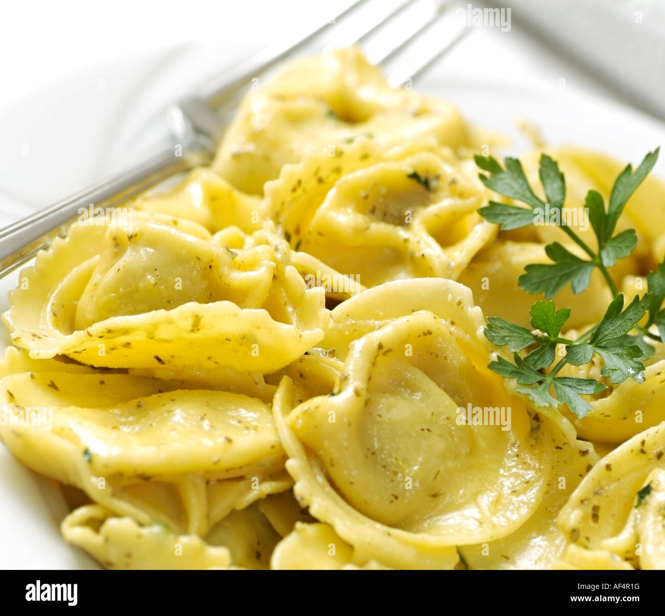 Ravioli Farciti Filled with Ricotta Cheese and Spinach and Served in a  Light Pesto Sauce Stock Photo - Alamy