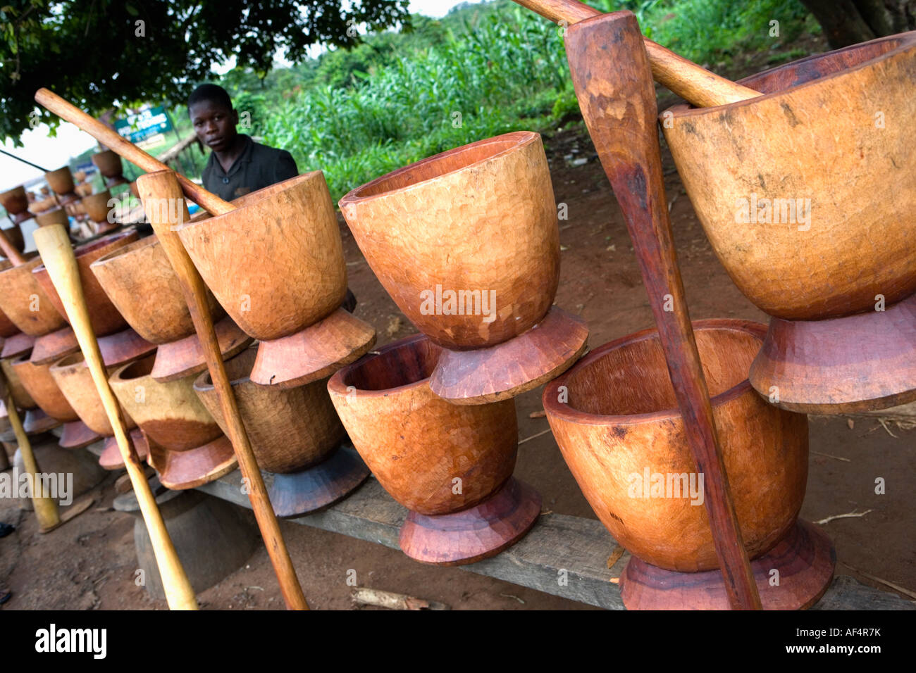 Nigeria Lagos Boy selling mortars and pestles for pounding food Stock Photo Alamy