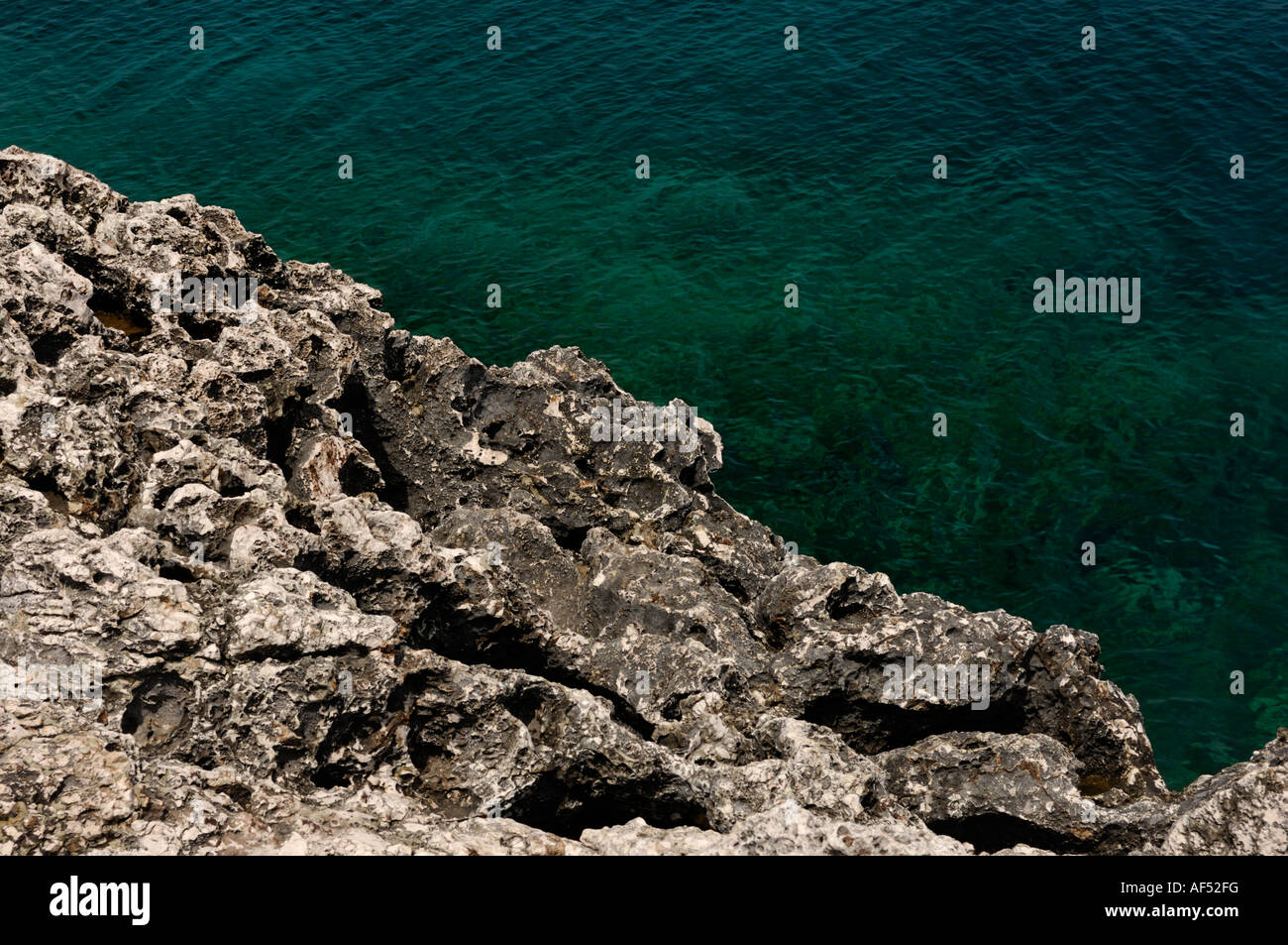 Rocky seashore of Mediterranean Sea water diagonal background Stock Photo
