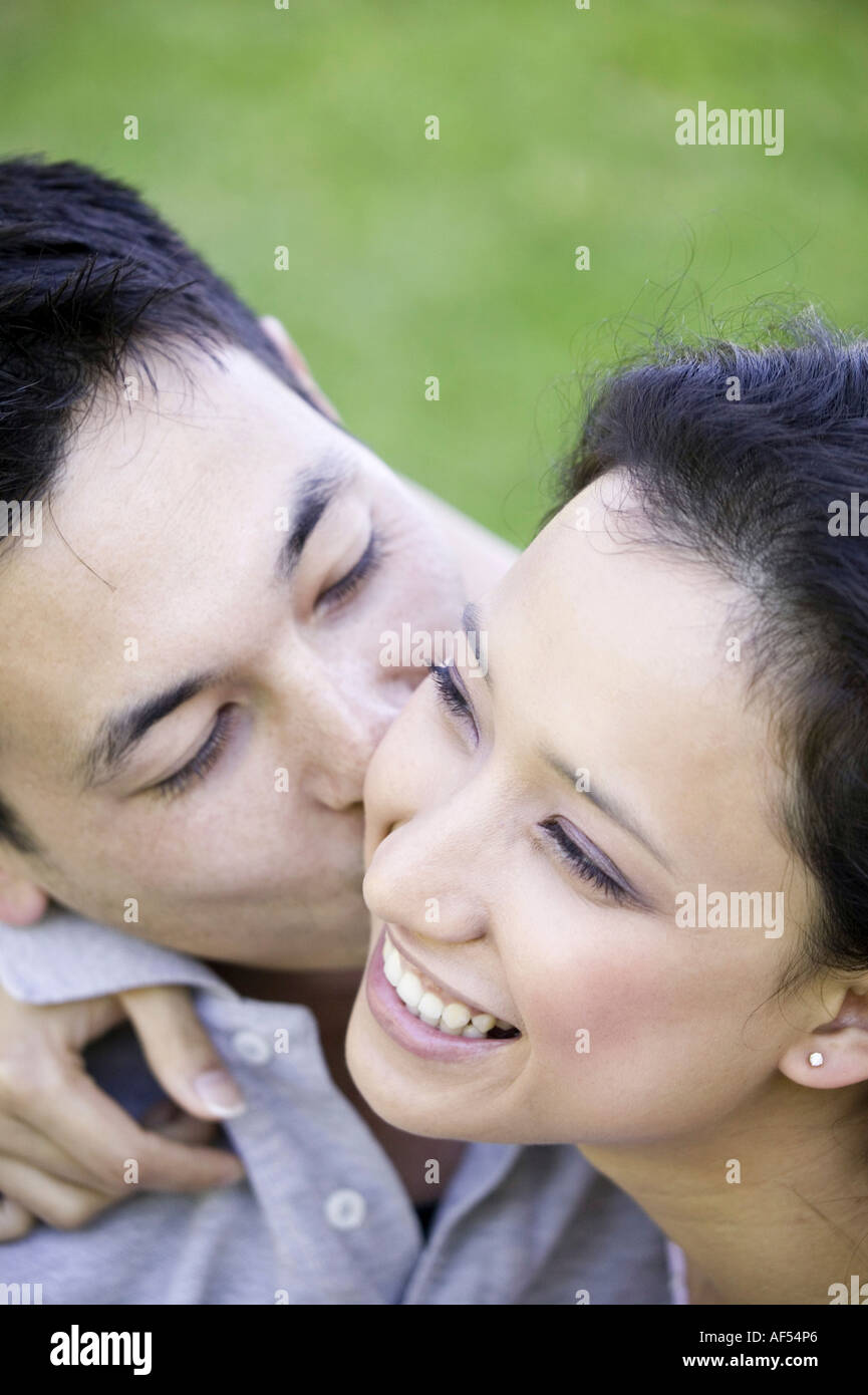 Close-up of a young man kissing a young woman Stock Photo - Alamy