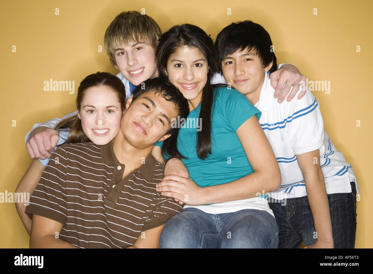 Portrait of three young men with two young women smiling Stock Photo ...