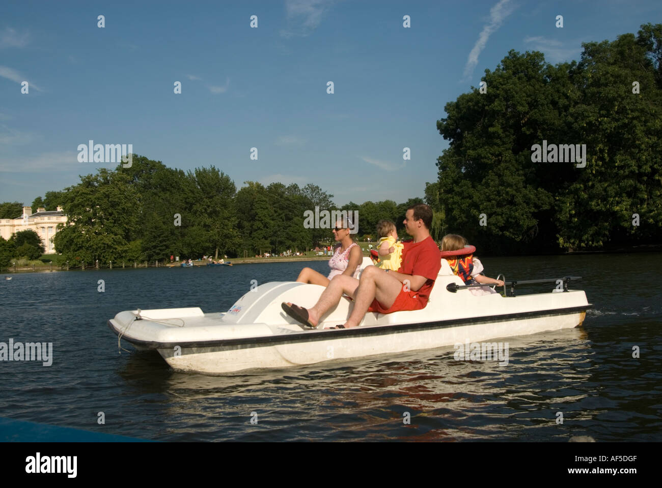 Family riding a pedalo on the boating lake in Regent's Park, London England UK Stock Photo