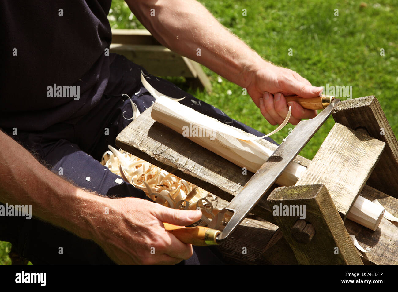 Traditional wood carving vice or clamp used with the draw knife or draw  blade to shape a cut piece of wood Stock Photo - Alamy