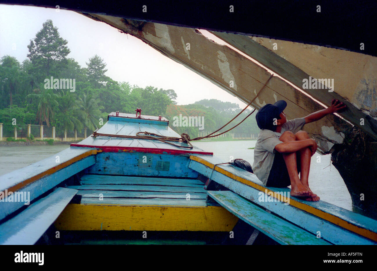 Vietnamese boy guide on a boat trip on the Saigon River in Ho Chi Minh ...