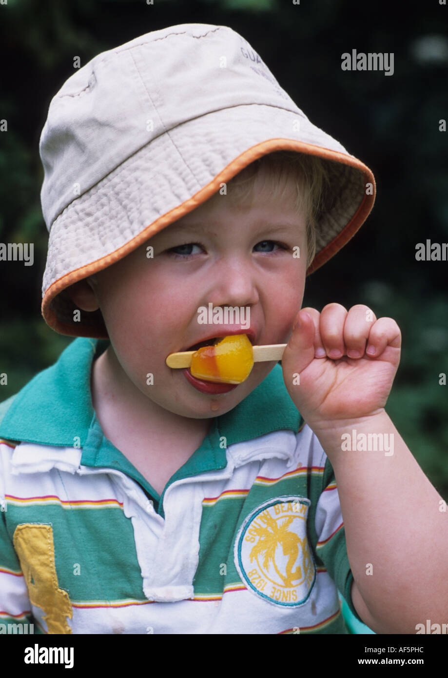 Two Year Old Boy Eating Ice Lolly in the Uk Stock Photo Alamy