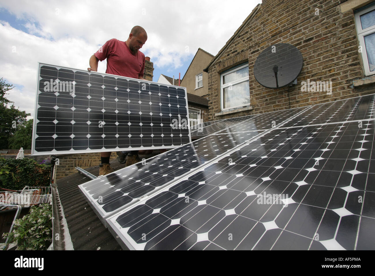 Solar panels being installed on the roof of a house in South East ...