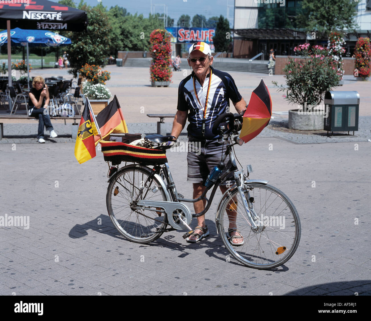 football world championship 2006 in Germany, Oberhausen, Ruhr area, North Rhine-Westphalia, fan party in the shopping centre Centro in Oberhausen, German football fan dressed in the national colors with a bicycle Stock Photo