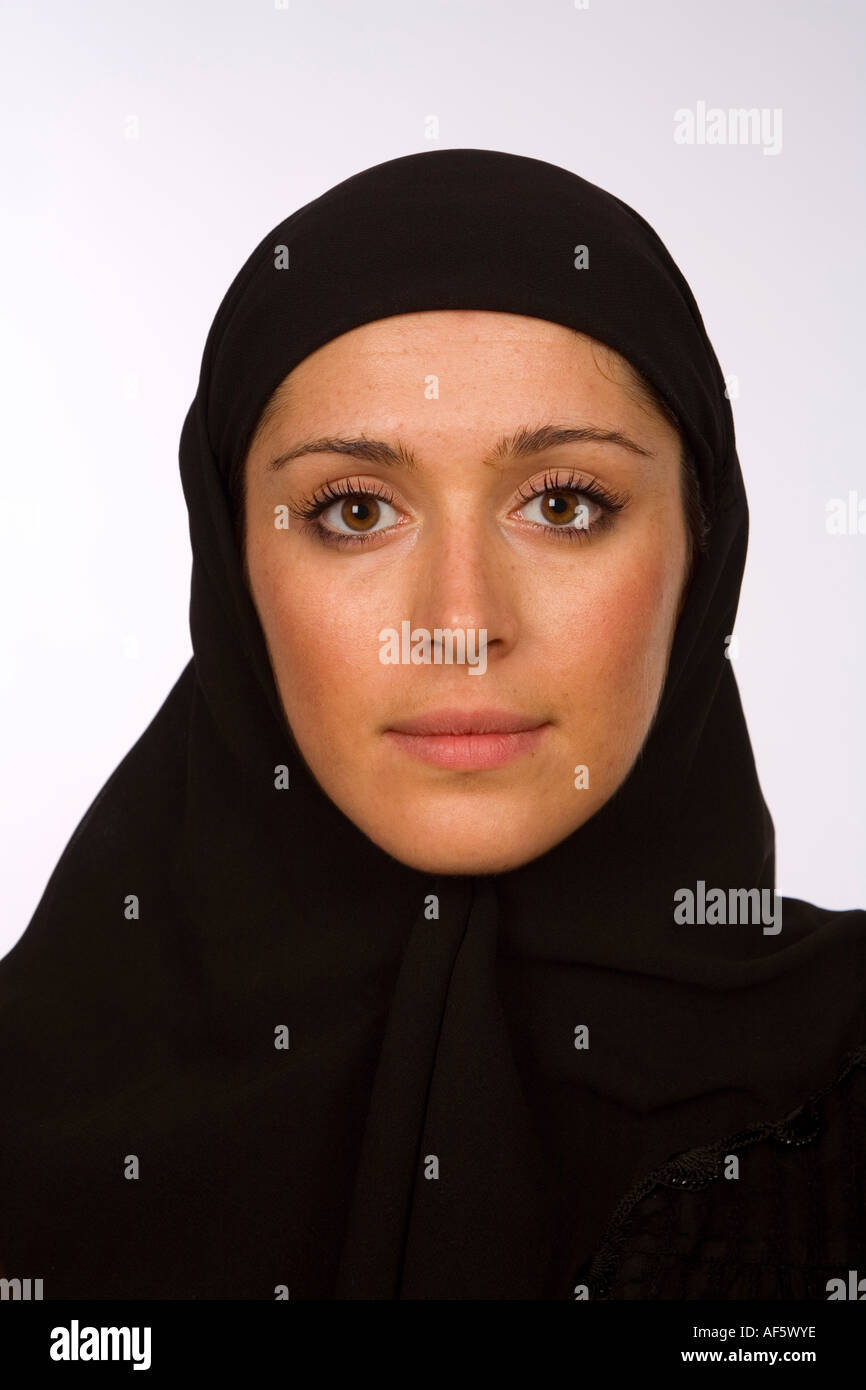 Close up head shot of a Muslim woman in a black hijab with eyes looking