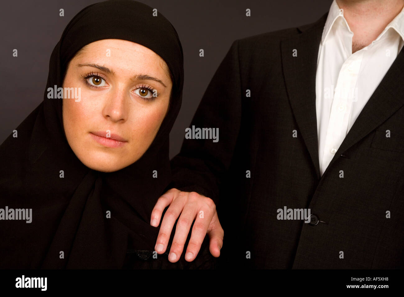 Man standing beside a Woman wearing a hijab burka Stock Photo - Alamy