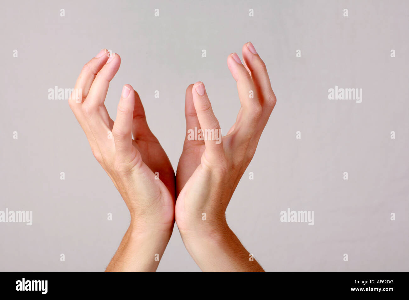 Hands held upwards in open gesture of faith hope peace love unity