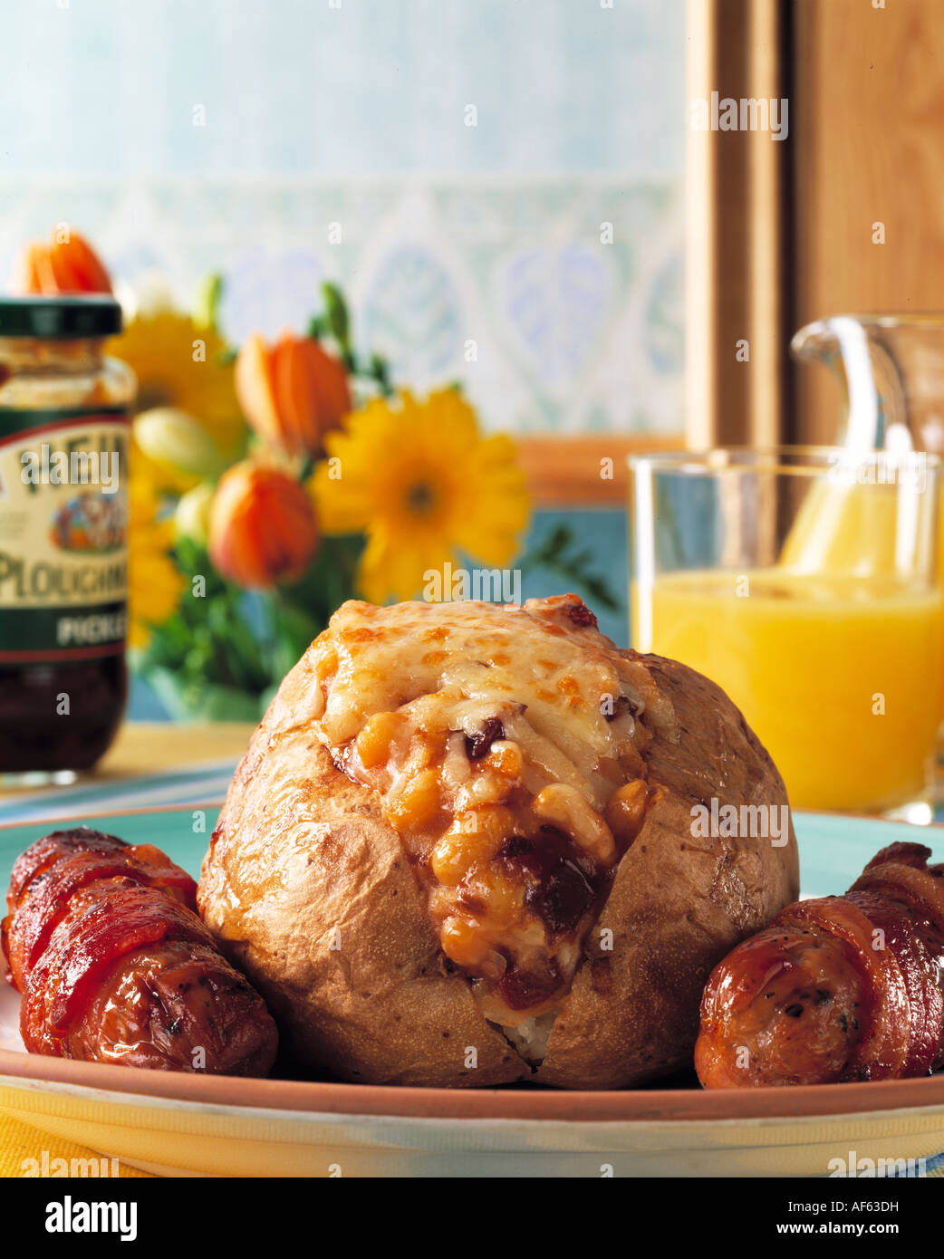 A baked potato with sausages and baked beans Stock Photo Alamy