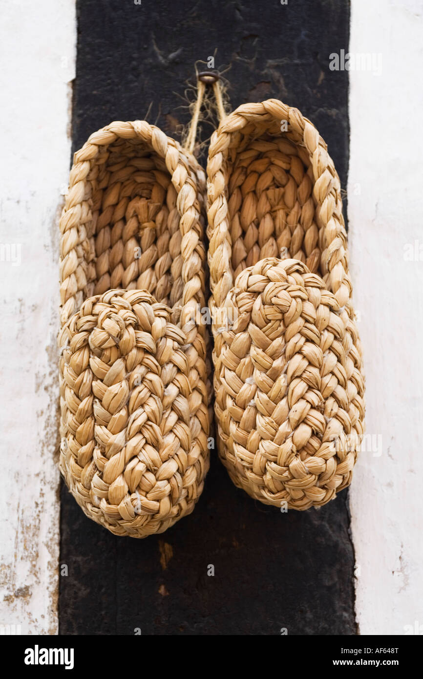 Viking Straw clogs hanging on a wall Stock Photo