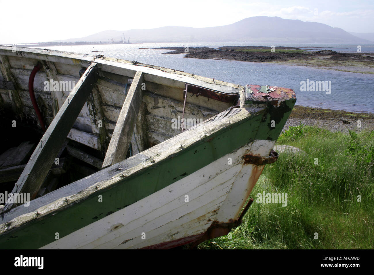 wreck of a small fishing boat on beach at Greencastle, County Down, Northern Ireland Stock Photo
