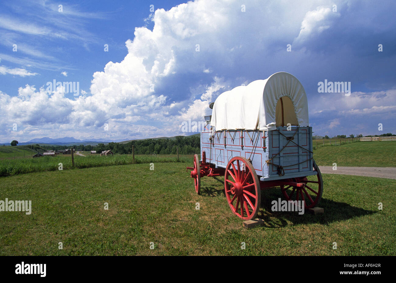 A conestoga wagon sits on the Great Plains on the U Bar Ranch a national historic site near Calgary, Canada. Stock Photo