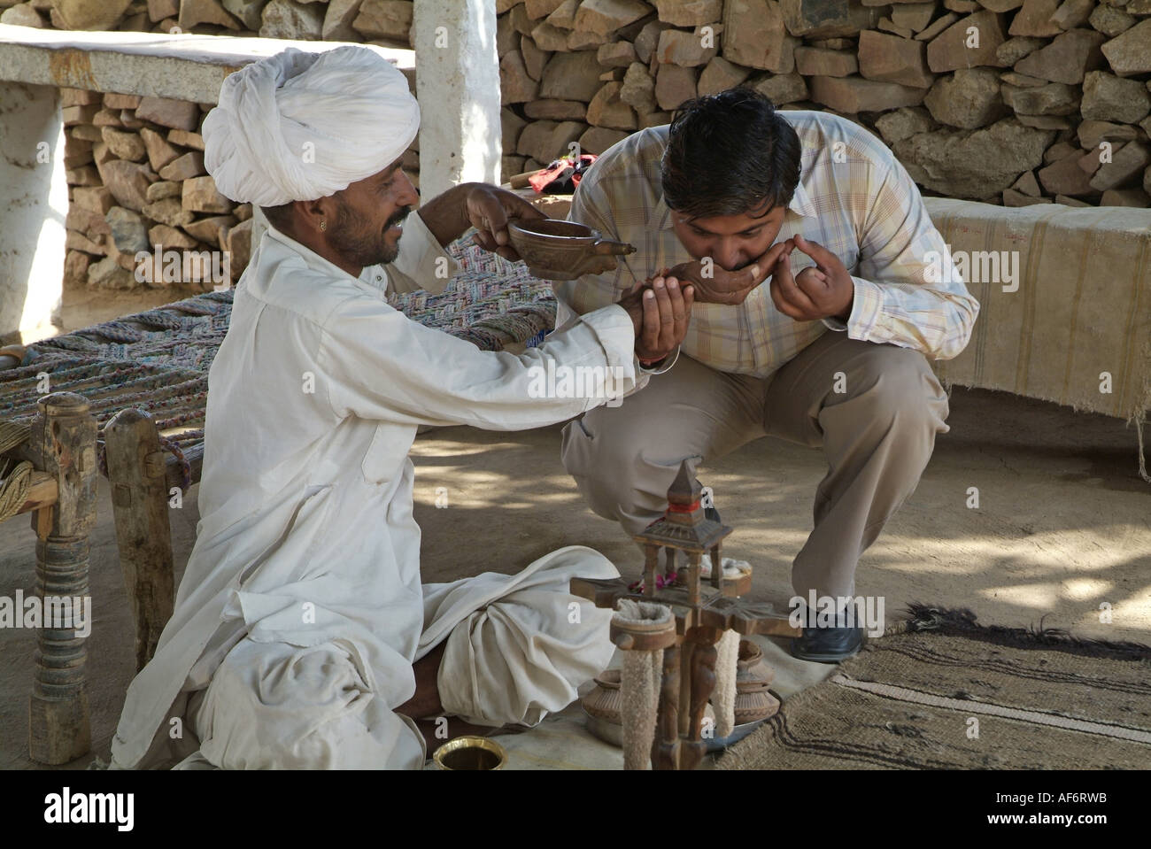 Man drinking opium in Rajasthan India Stock Photo