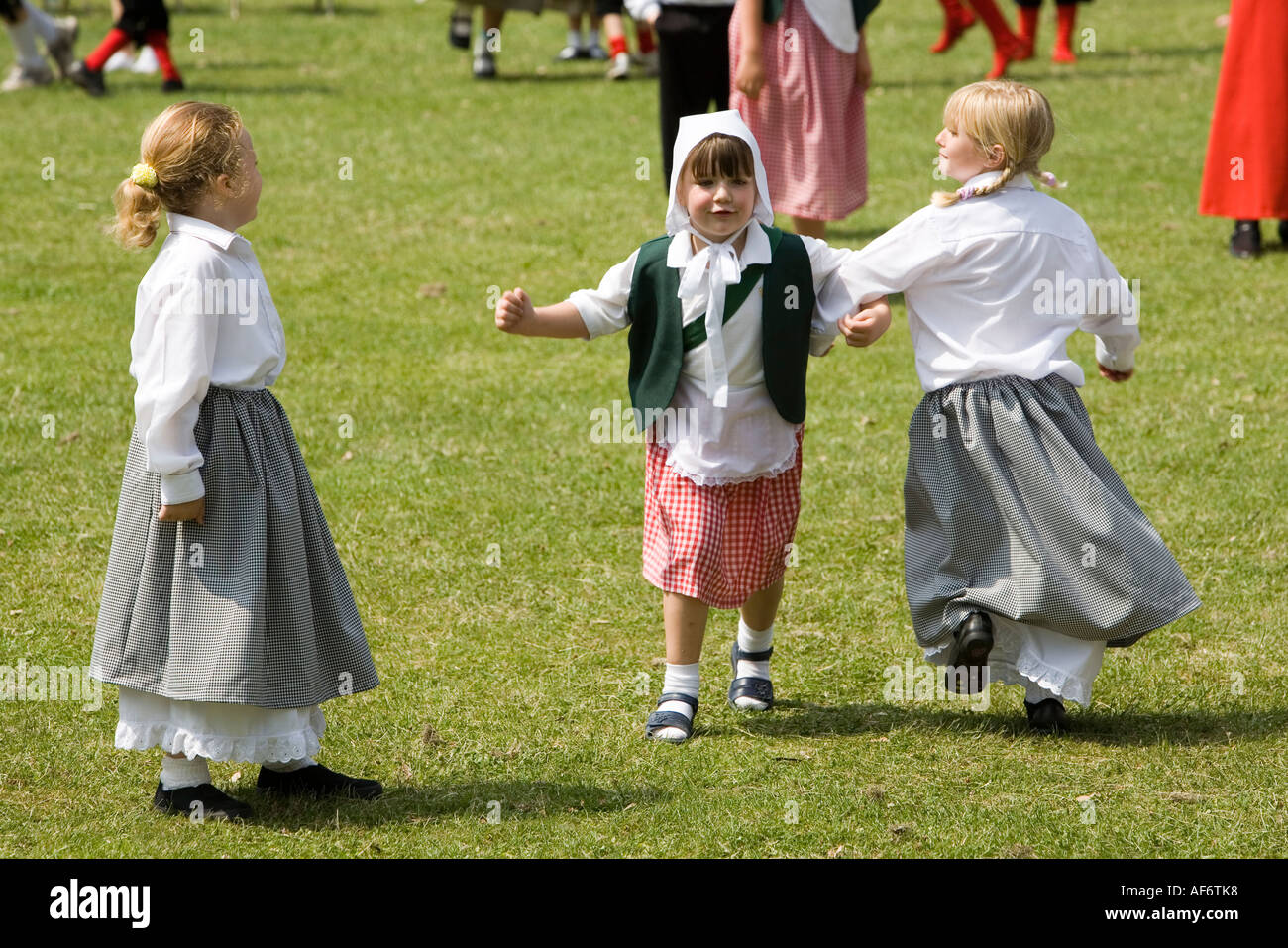 Children in traditional costume country dancing at a festival in a
