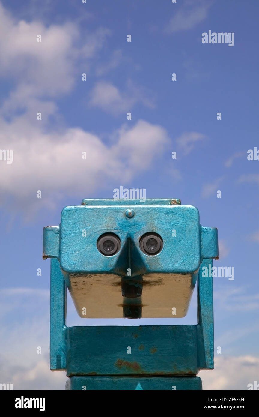Coin operated beach binoculars against a bright blue cloudy sky Stock Photo