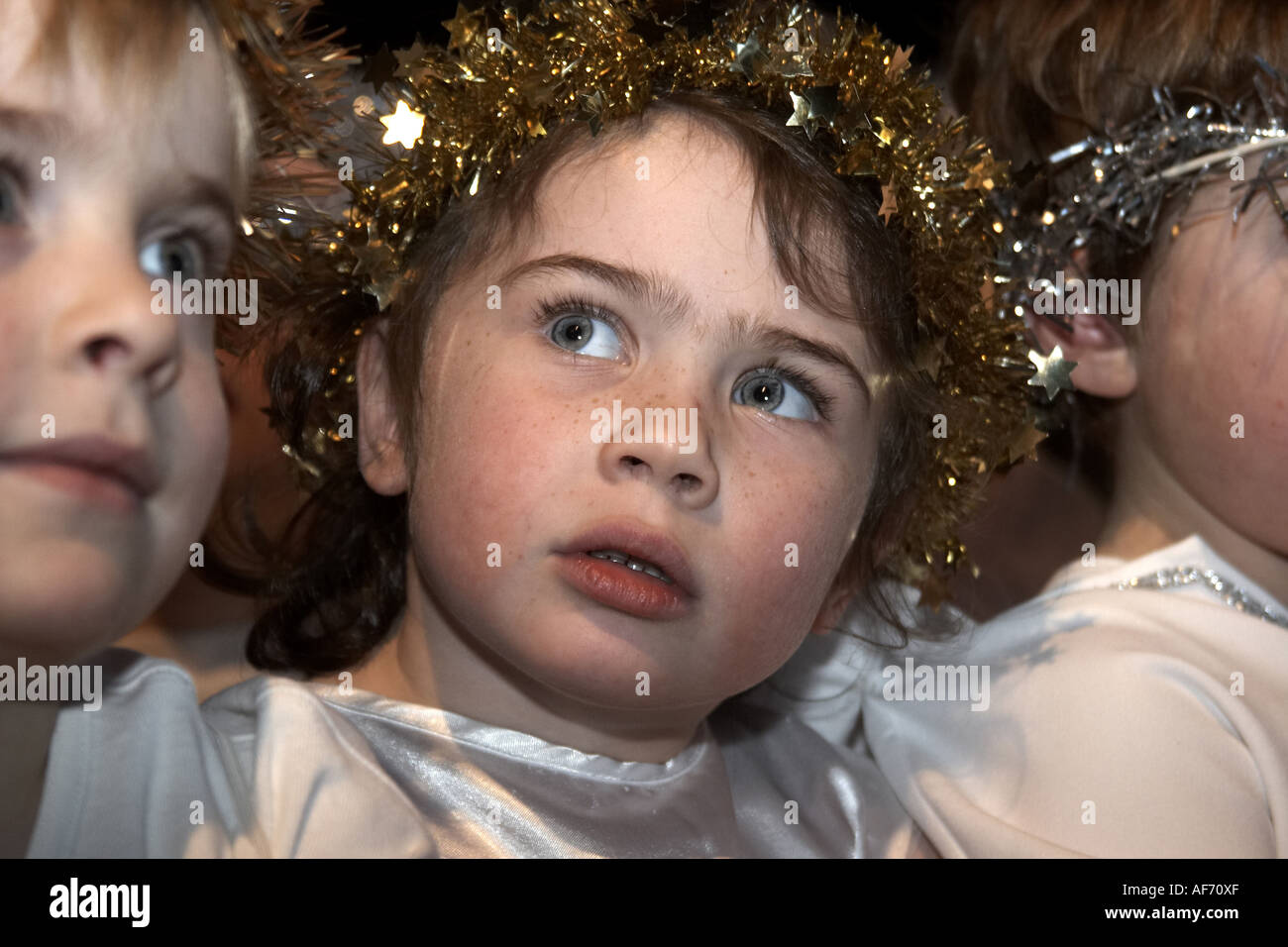 Attractive young girl child dressed as angel in primary school nativity