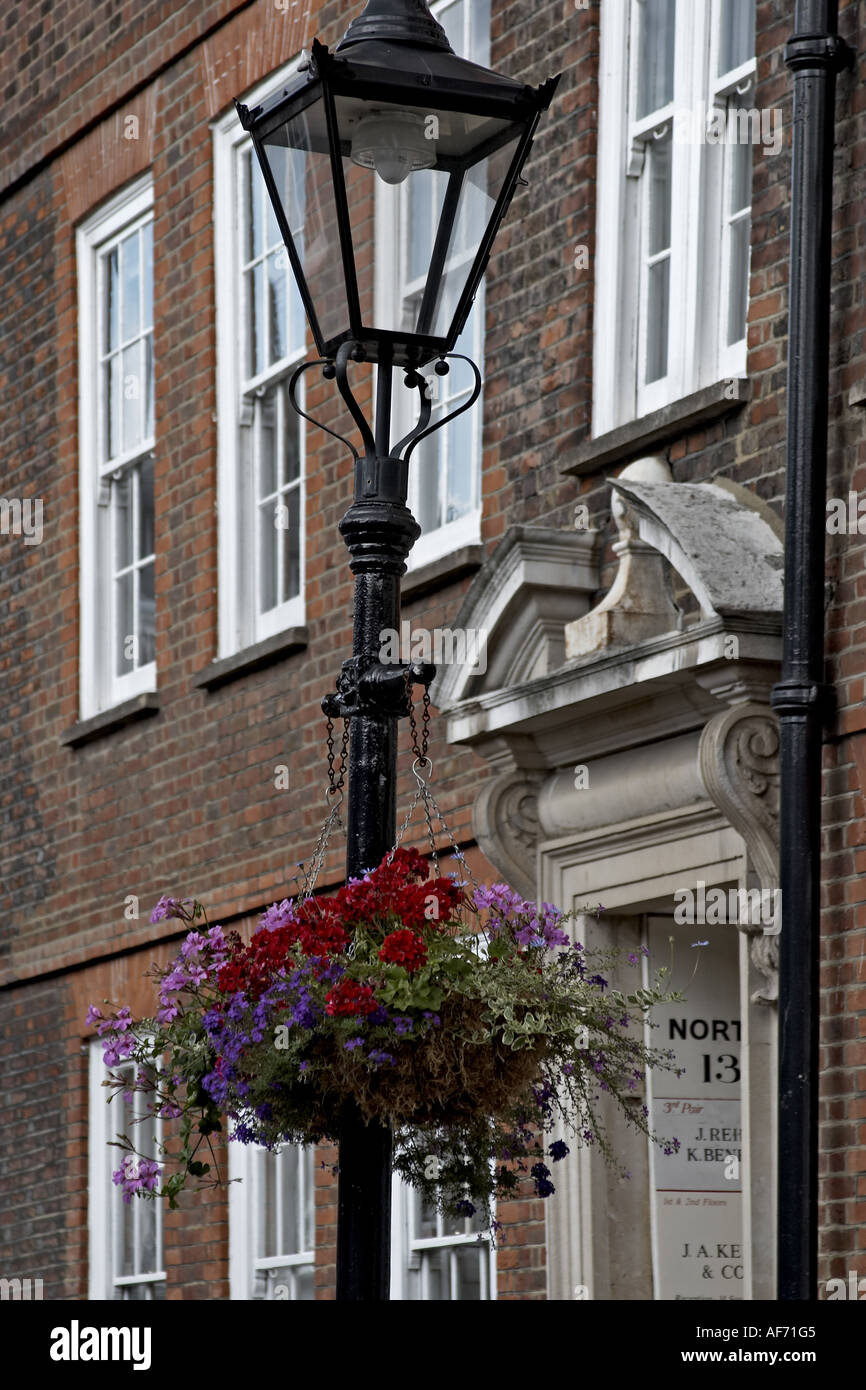 Lamp post and hanging flower basket with Georgian buildings in Grey s Inn  Square Inns of Court with barrister s chambers London Stock Photo - Alamy