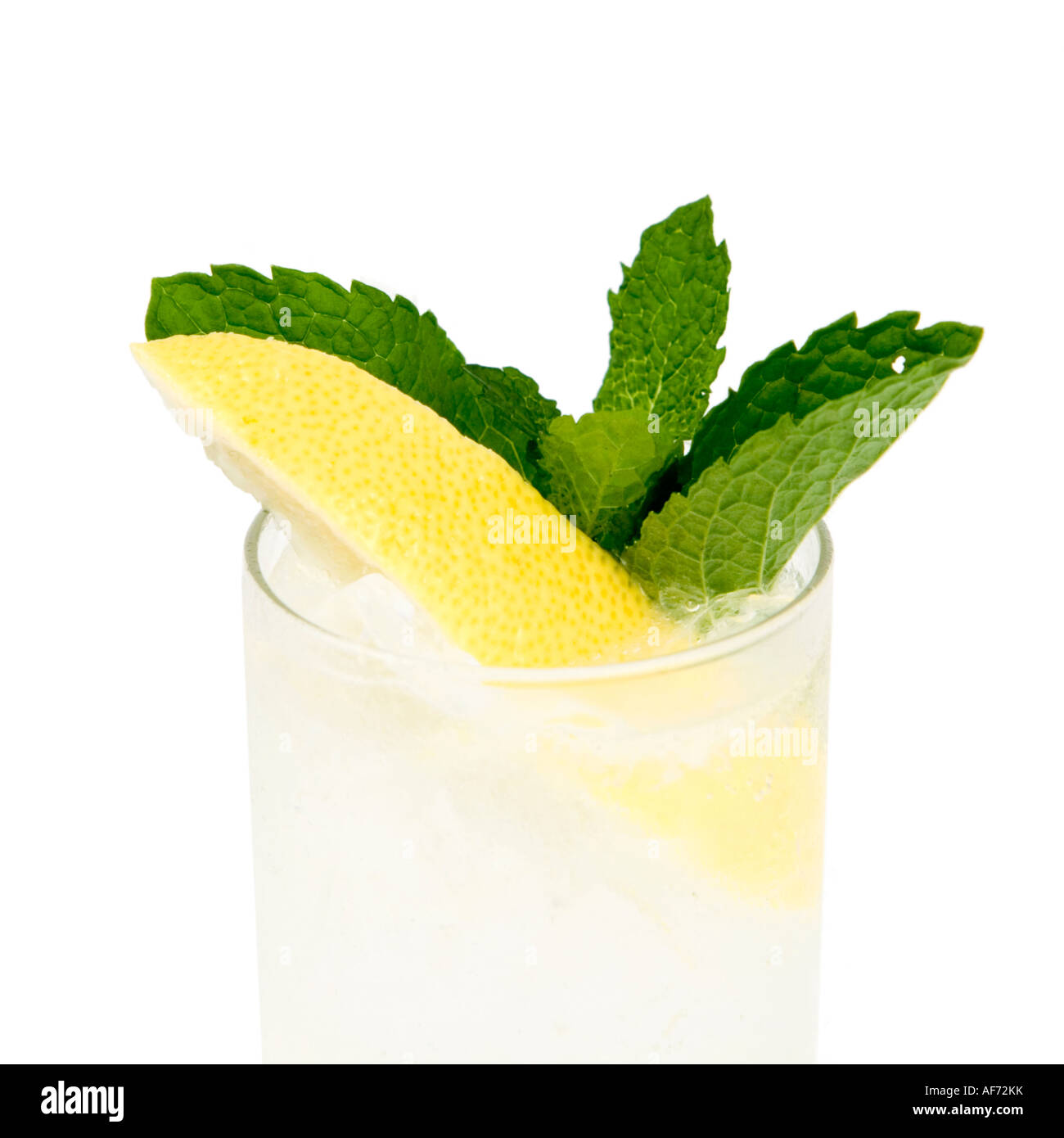 A high key image of a cocktail made with limoncello in a tall glass with a lemon and mint garnish Stock Photo