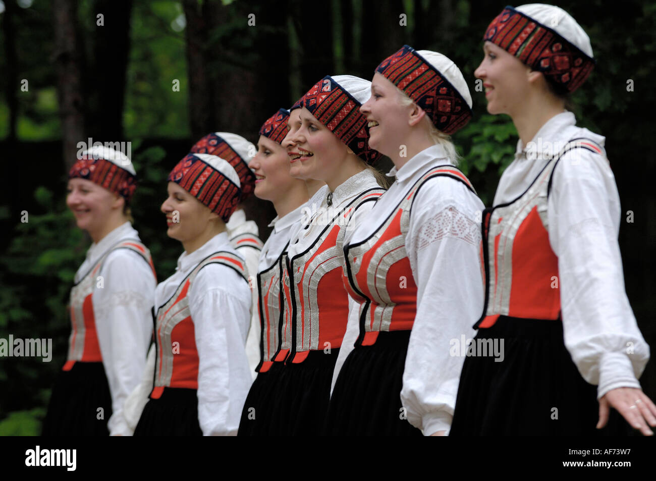Traditional Latvian folk dancing, performed at the Lativan Open Air Ethnographic Museum (Latvijas etnografiskais brivdabas muzejs), near Riga, Latvia - SHALLOW DOF Stock Photo